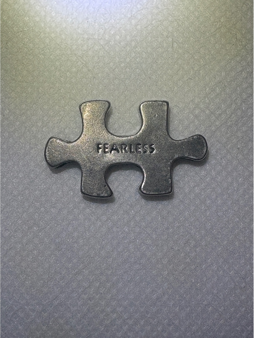 Silver Tone Puzzle Piece Charm with 'FEARLESS' Engraving, Approx. 1 Inch